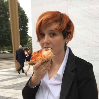 It's a picture of me! I'm eating pizza outside the Kennedy Center in Washington, DC. I had bright orange hair at the time.